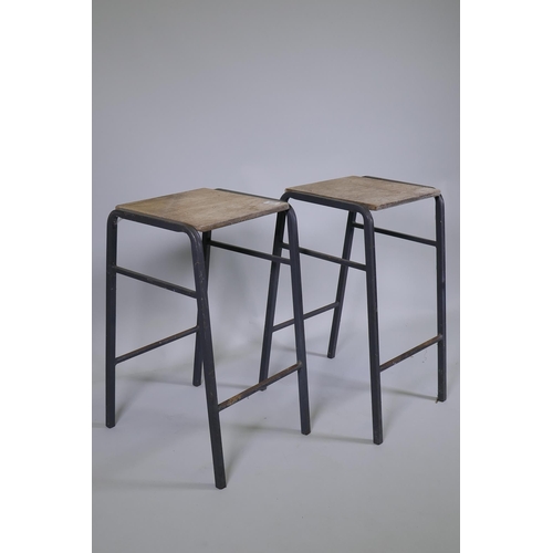 1171 - A pair of vintage industrial laboratory stools, with steel frames and ply seats, 52cm high