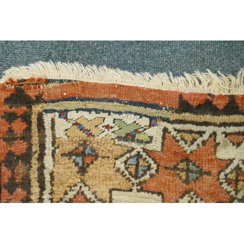 1129 - A multi colour ground Kurdish Kazak wool runner with a geometric medallion design on a brown field, ... 