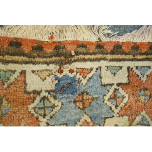 1129 - A multi colour ground Kurdish Kazak wool runner with a geometric medallion design on a brown field, ... 