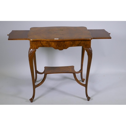 1128 - A burr walnut centre table, with shaped top and pull out slides, raised on carved cabriole supports ... 