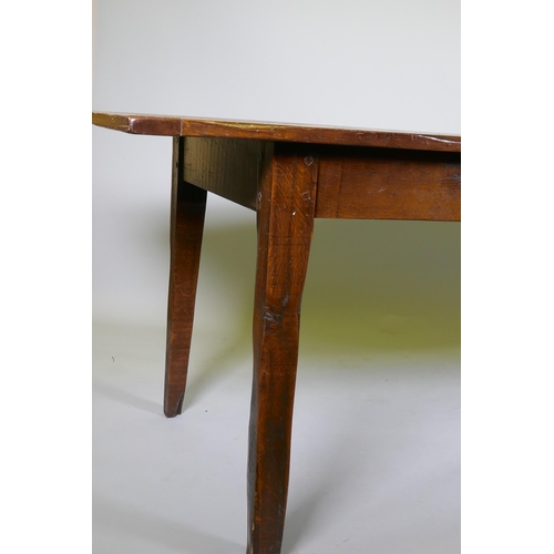 1136 - A French style oak farmhouse table with single drawer and cleated plank top, raised on square taperi... 