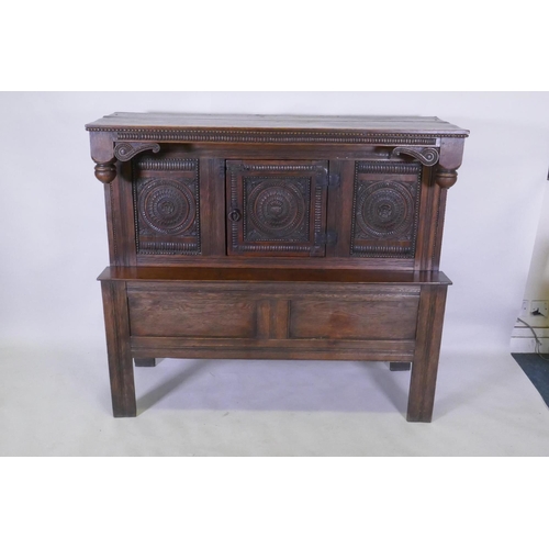 1154 - Late C18th/early C19th French oak side/food cupboard, with triple panel front and single door, carve... 