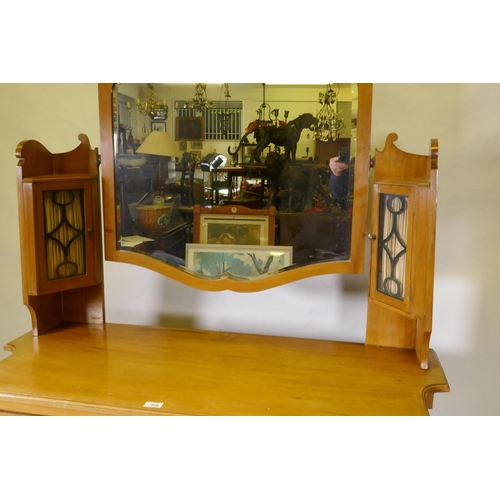 1159 - A Victorian satinwood dressing table, the upper section with mirror flanked by glazed cabinets, the ... 