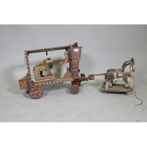 1 - A C19th Folk Art scratch built circus wagon with lions and lion tamer, with moving limbs operated by...