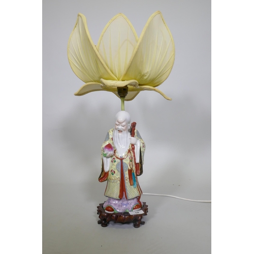 10 - A Chinese porcelain table lamp in the form of Shao Lao holding a peach and staff with dragon's head,... 