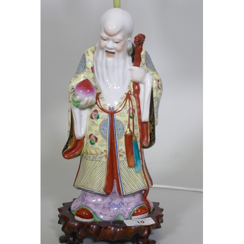 10 - A Chinese porcelain table lamp in the form of Shao Lao holding a peach and staff with dragon's head,... 