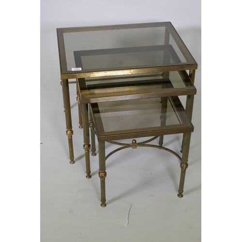 1003 - A mid century nest of three brass occasional tables with tinted glass tops, 56 x 46 x 47cm