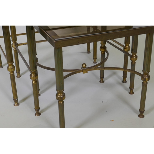 1003 - A mid century nest of three brass occasional tables with tinted glass tops, 56 x 46 x 47cm