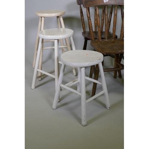 1007 - Four Windsor stick back kitchen chairs with elm seats, and three painted stools