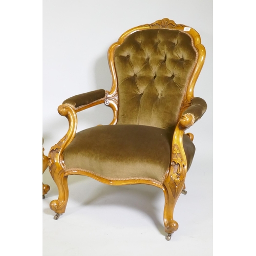 1008 - A Victorian gentleman's walnut show frame armchair with carved decoration, raised on cabriole suppor... 