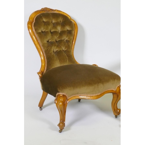 1008 - A Victorian gentleman's walnut show frame armchair with carved decoration, raised on cabriole suppor... 