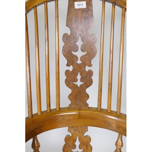 1011 - A yew wood hoopback rocking chair with pierced splat and elm seat