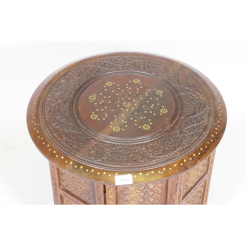 1014 - An Indian rosewood Hoshiarpur table with brass inlay and cared floral decoration, with folding octag... 