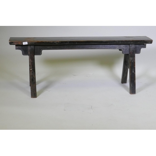 1019 - An antique oriental hardwood trestle shaped bench, 131 x 35 x 51cm high