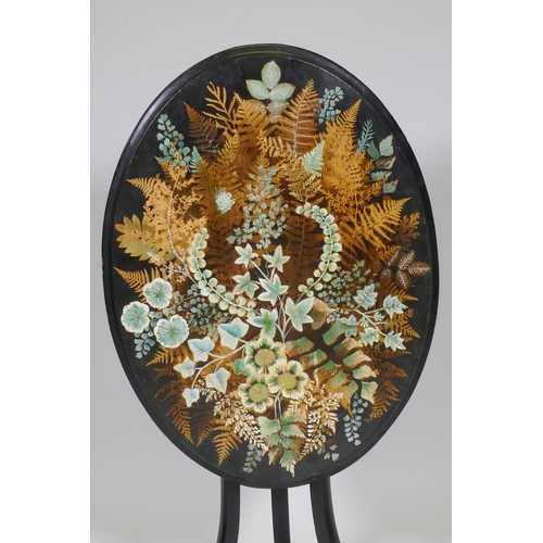 1020 - A Victorian ebonised tilt top occasional table with painted and stencilled fern decorated top, 51cm ... 