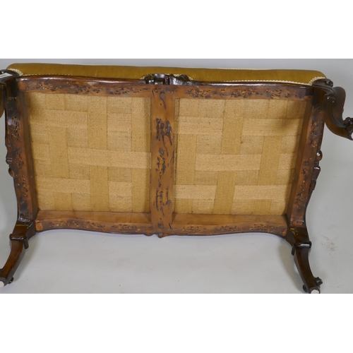 1029 - A C19th carved walnut stool with shaped frieze raised on cabriole supports with scroll feet, 82 x 50... 