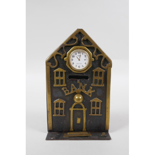 103 - A Victorian brass mounted metal money box in the form of a bank, with later applied watch movement, ... 