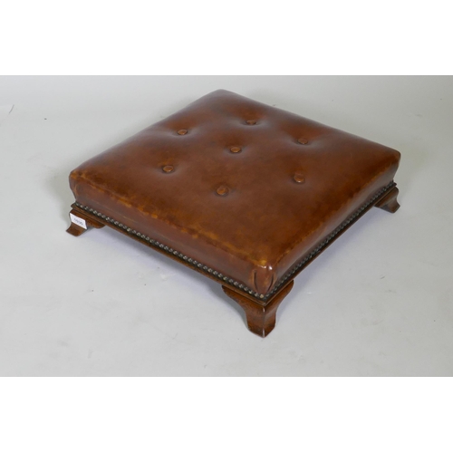 1030 - An antique button leather footstool, raised on swept supports, 46 x 46 x 13cm