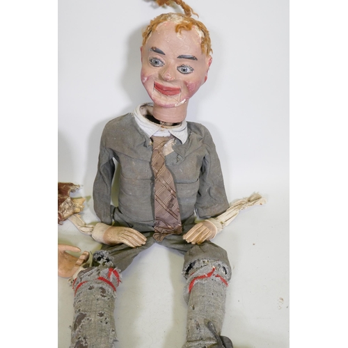 104 - Four early C20th ventriloquist's dummy heads, paper mache with glass eyes, and two associated bodies... 