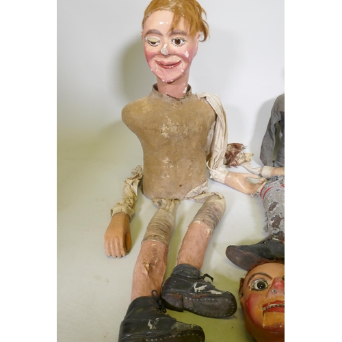 104 - Four early C20th ventriloquist's dummy heads, paper mache with glass eyes, and two associated bodies... 