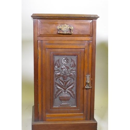 1040 - A pair of Victorian walnut bedside cabinets with single drawer over carved cupboard door, raised on ... 