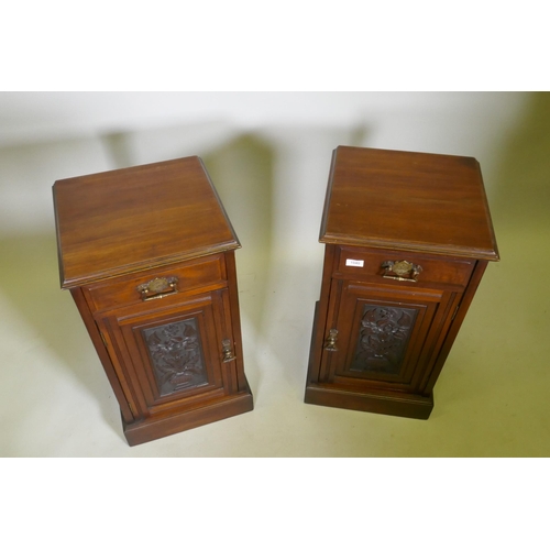 1040 - A pair of Victorian walnut bedside cabinets with single drawer over carved cupboard door, raised on ... 