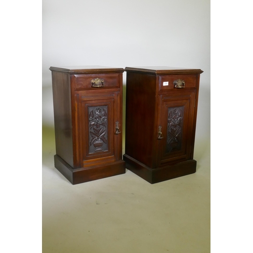 1040 - A pair of Victorian walnut bedside cabinets with single drawer over carved cupboard door, raised on ... 