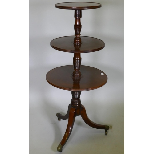 1041 - A Georgian mahogany dumb waiter with three revolving tiers, each united by a 'beehive' style ring co... 