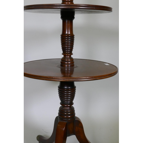 1041 - A Georgian mahogany dumb waiter with three revolving tiers, each united by a 'beehive' style ring co... 