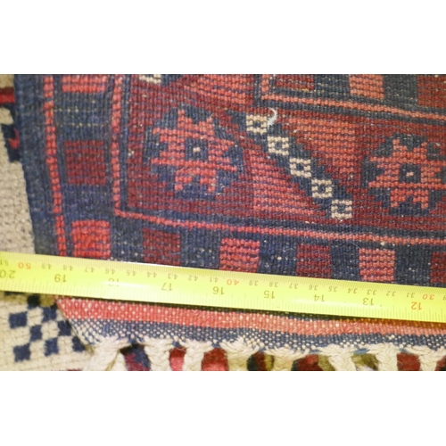 1061 - A Caucasian Kazak wool carpet with geometric designs on a red field, 200 x 300cm