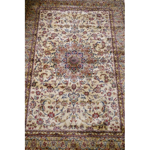 1063 - A Kashmiri ivory ground full pile rug with all over floral design, 117 x 170cm