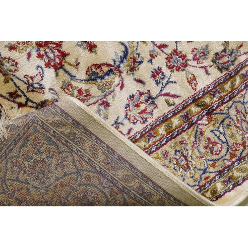 1063 - A Kashmiri ivory ground full pile rug with all over floral design, 117 x 170cm