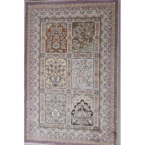 1064 - A pair of fine woven bamboo silk rugs with traditional Persian panel designs on a lilac coloured fie... 