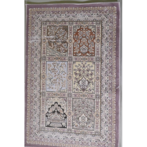 1064 - A pair of fine woven bamboo silk rugs with traditional Persian panel designs on a lilac coloured fie... 