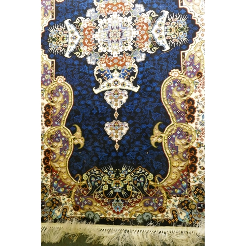 1066 - An Iranian fine woven runner with floral medallion design on a deep blue field, 100x  410cm