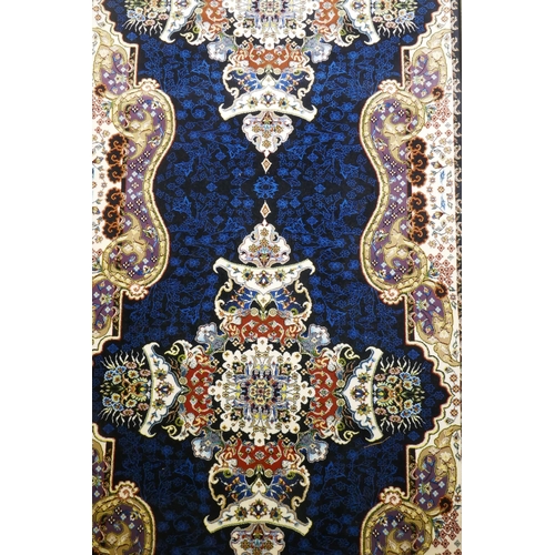 1066 - An Iranian fine woven runner with floral medallion design on a deep blue field, 100x  410cm