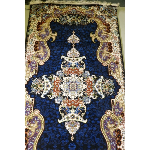 1066 - An Iranian fine woven runner with floral medallion design on a deep blue field, 100x  410cm