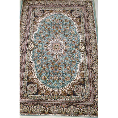 1068 - A fine woven full pile Iranian carpet with traditional floral medallion design on a turquoise field,... 