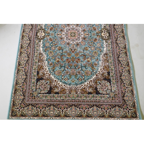 1068 - A fine woven full pile Iranian carpet with traditional floral medallion design on a turquoise field,... 