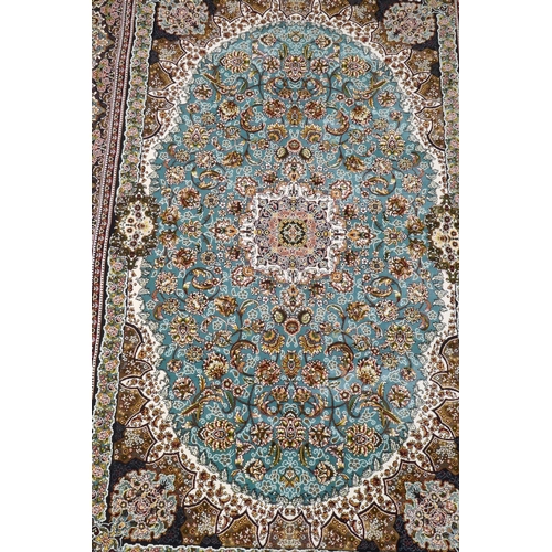 1068 - A fine woven full pile Iranian carpet with traditional floral medallion design on a turquoise field,... 