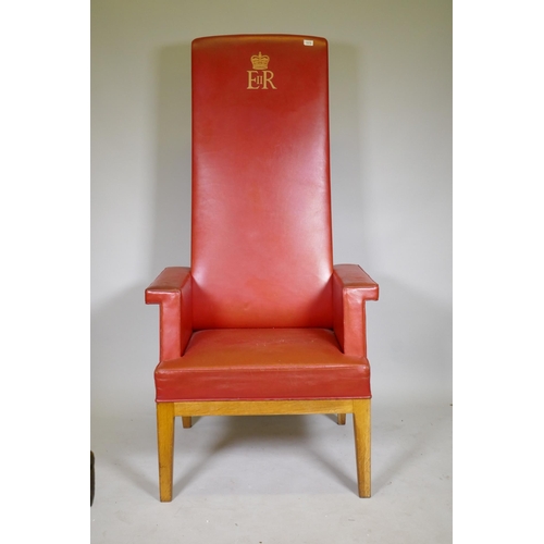 1070 - A vintage magistrate's high back oak throne chair with red leather covers and ER II cypher, 165cm hi... 