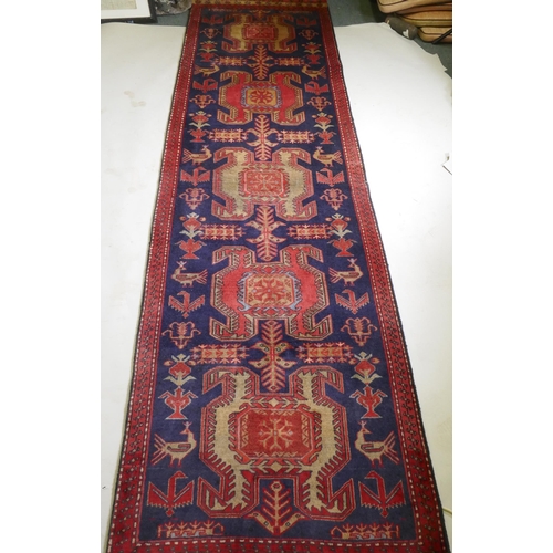 1071 - A fine woven Iranian runner, with bespoke medallion design on a rich blue field, 90 x 305cm