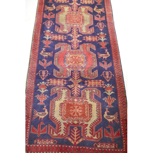 1071 - A fine woven Iranian runner, with bespoke medallion design on a rich blue field, 90 x 305cm