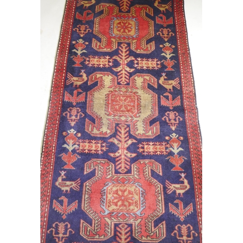 1071 - A fine woven Iranian runner, with bespoke medallion design on a rich blue field, 90 x 305cm