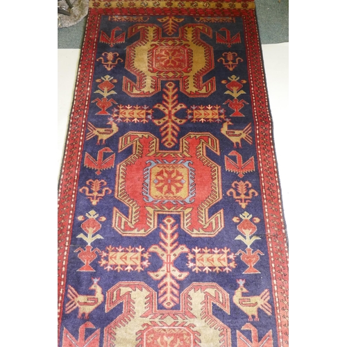 1071 - A fine woven Iranian runner, with bespoke medallion design on a rich blue field, 90 x 305cm