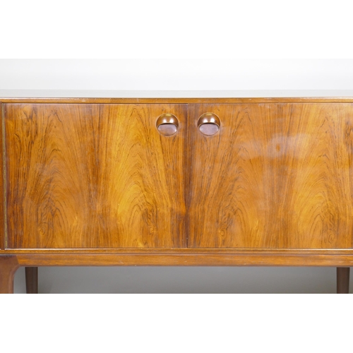 1073 - A mid century A.H. McIntosh & Co Ltd rosewood sideboard, with two cupboards flanked by three dra... 