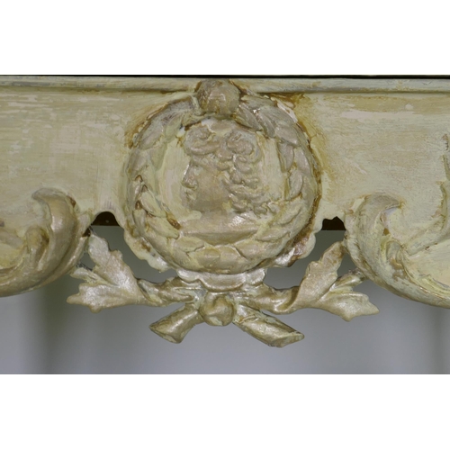 1074 - An Italian painted pine and parcel gilt side table, the shaped top with painted floral decoration an... 