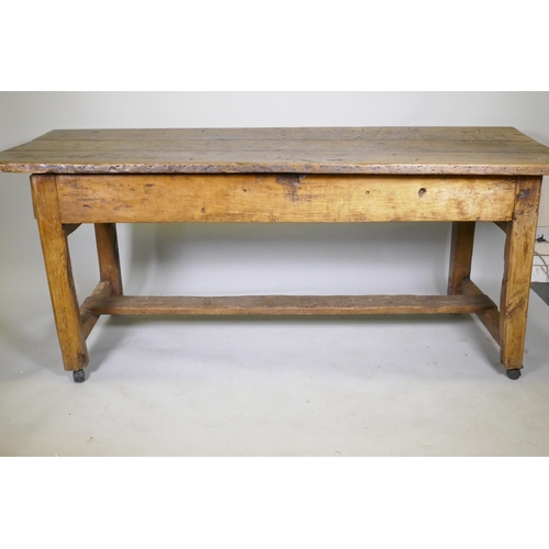 1080 - An C18th fruit wood refectory table with oak planked top and raised on square chamfered supports uni... 