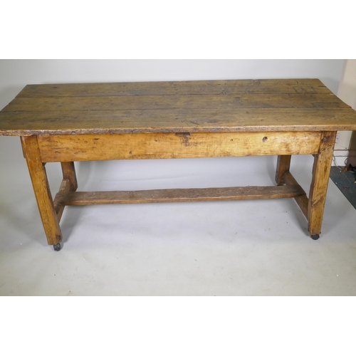 1080 - An C18th fruit wood refectory table with oak planked top and raised on square chamfered supports uni... 