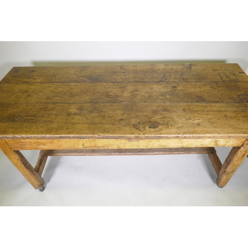 1080 - An C18th fruit wood refectory table with oak planked top and raised on square chamfered supports uni... 